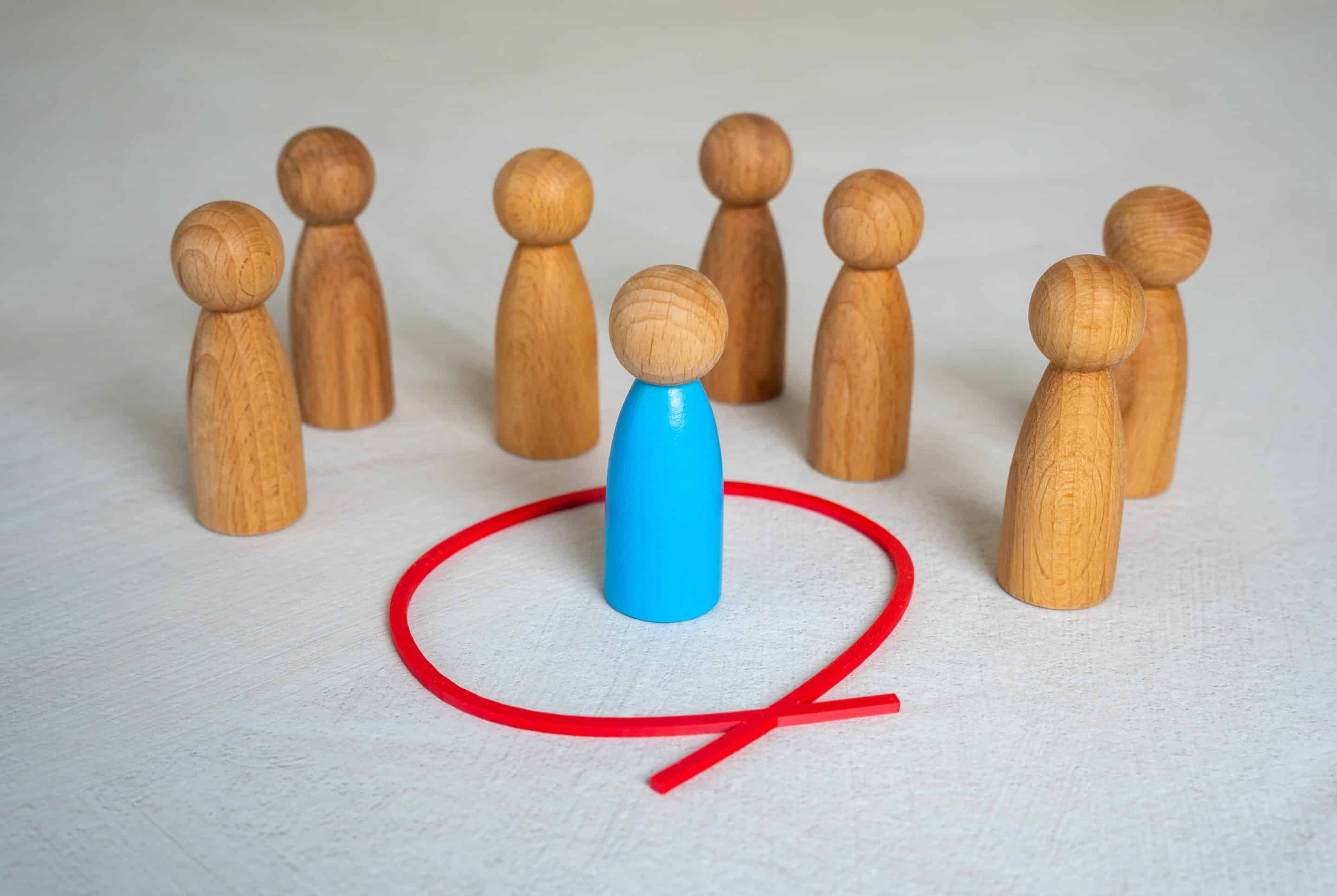 The blue human figure is separated from the rest of the people by a red circle. Personal space. Setting boundaries. Isolation from society. Individuality, or setting healthy personal limits.
